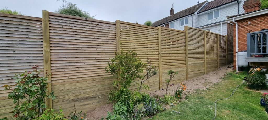 Louvre fence panels stacked between Heavy Duty Slotted posts